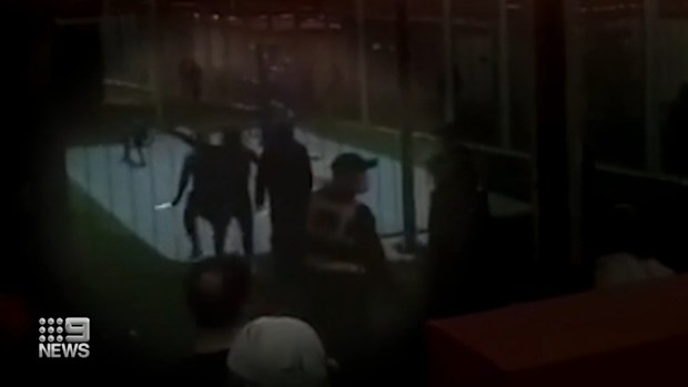 Footage shows one detainee swings a weapon, as another is whisked away by security, before the riot squad, swoops in taking two inmates into custody. 