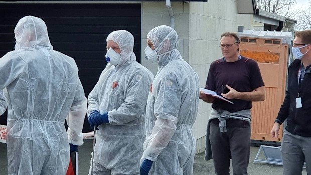 Police forensics officers at the house.