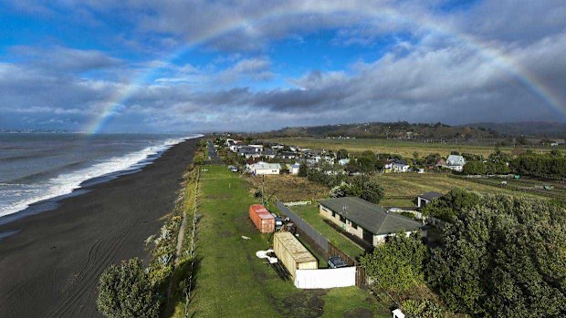 Simon Bicknell and Carol McLennan have erected a 2m high fence, further blocking the view of their neighbours John and Judy Dewar. The fence was erected in late March and joins two shipping containers, a digger, and several car bodies.