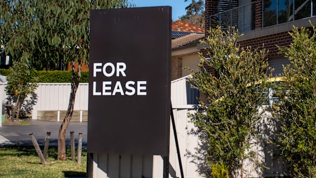 For lease sign on a blue display outside of a resedential building in Australia. Investment property real estate concept