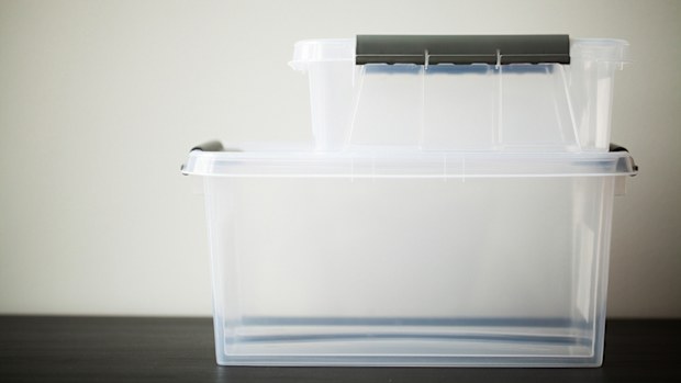 Transparent drawers for storing things on a wooden table.
