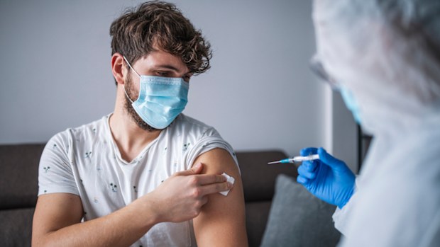 Man getting vaccinated. Vaccine. Needle