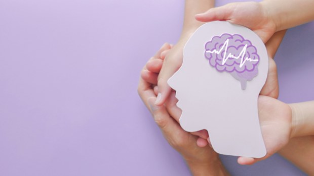Adult and child hands holding encephalography brain paper cutout,autism, Stroke, Epilepsy and alzheimer awareness, seizure disorder, stroke, ADHD, world mental health day concept