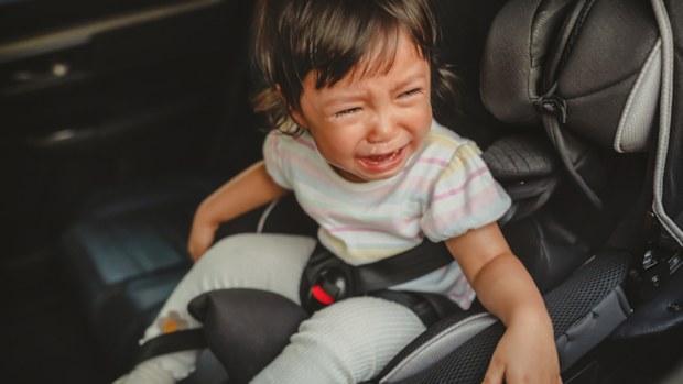 Crying toddler in a car seat