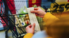 Woman checking the bill when paying at a supermarket
