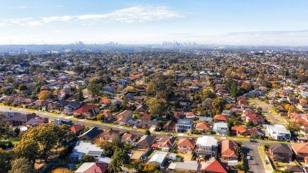 City of Ryde residential suburbs of Greater Sydney in Australia - aerial view towards distant city CBD on horizon.