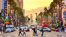 LOS ANGELES, CALIFORNIA - MARCH 1, 2016: Traffic on Hollywood Boulevard at dusk. The theater district is famous tourist attraction.