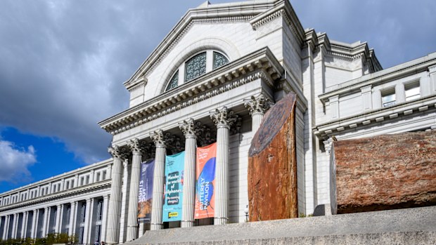 Washington, DC -January 26, 2024: The exterior of the Smithsonian Institution Museum of Natural History. Petrified wood is displayed on a platform on front of the museum.