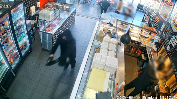 Two men with masks and clad in black stormed into the kebab shop with guns.