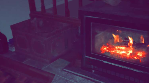 A blurry image of a fireplace that is lit