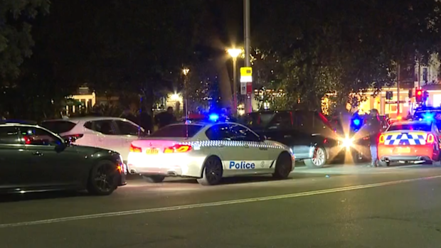 Police cars swarm the allegedly stolen black Range Rover.
