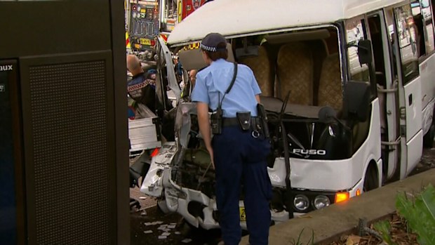 Five people have been taken to hospital after a mini-bus collided with a ute in Sydney's CBD. (9NEWS)