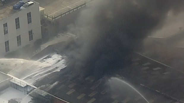 Firefighters are warning nearby residents to stay indoors and shut their windows to avoid inhaling the smoke.