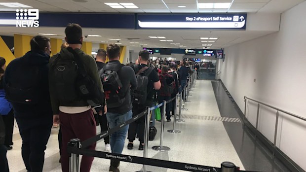 Incoming passengers at Sydney airport wait in line after tough new self-isolation measures were rolled out in Australia.