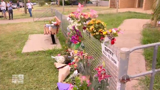 Some residents left flowers outside of the police station, while others hugged and offered condolences to their colleagues.