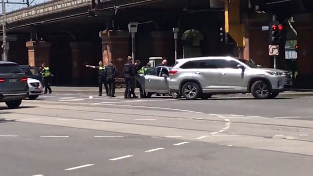 Officers appeared to focus their attention on a silver sedan.