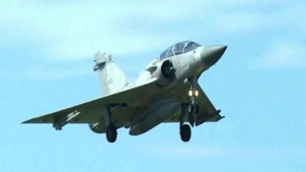In this image taken off video, a Taiwan fighter jet prepares to land at the Hsinchu Airbase in Taiwan on Monday, Dec. 29, 2025. (AP Photo/Wu Taijing)