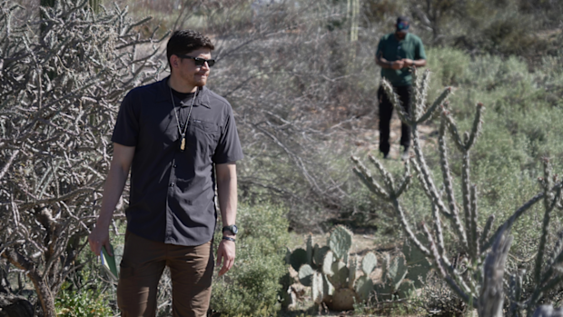 Law enforcement agents check vegetation areas around Nancy Guthrie's home in Tucson, Arizona.