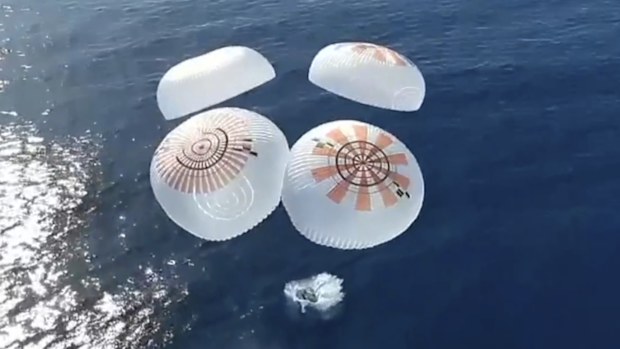 In this image from video provided by SpaceX, the Dragon capsule carrying four space tourists splashes down in the Pacific Ocean off the coast of California on Friday, April 4, 2025. (SpaceX via AP)