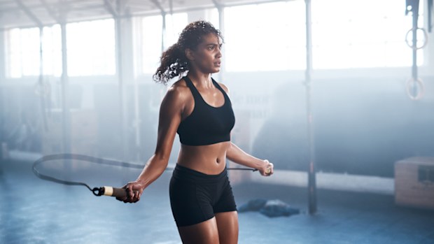 Cropped shot of an attractive and athletic young woman jumping rope in the gym