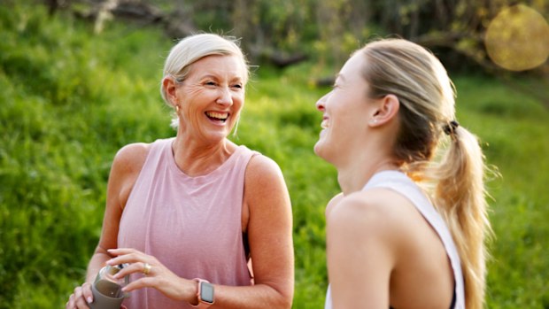 Fitness, laughing and mom with girl in nature for workout, outdoor exercise or wellness for health. Mature mother, daughter or happy women in park for training, sports routine or bonding