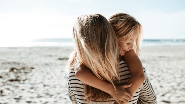 Mum with daughter on a beach