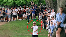 A young fan reacts to Min Woo Lee's shot out of the rough. 