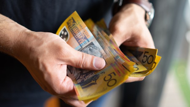 Cash stock image of cash person holding cash Australian money