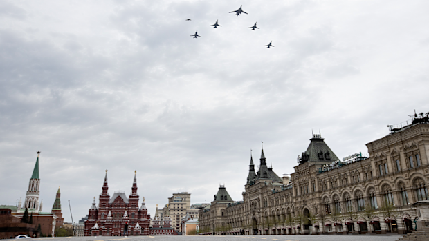 bombers, Tu-160, right, and Tu-22M3, all others, fly over almost empty Red Square in Moscow, Russia, Monday, May 4, 2020. The Russian air force conducted a rehearsal of the flyover intended to mark the 75th anniversary of the victory over the Nazis on May 9, but the planned military parade is postponed due to the coronavirus outbreak, leaving only the flyby. (AP Photo/Alexander Zemlianichenko)