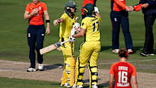 Ellyse Perry celebrates with teammate Meg Lanning.