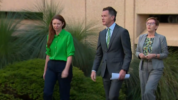 Chris Minns and Tabitha Acret walking on a footpath before announcing landmark domestic violence law reforms