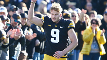 Australian-born punter Tory Taylor running out onto the field for the Iowa Hawkeyes.