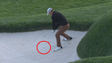 Adam Scott attempts to hit out of the bunker on the 18th hole.