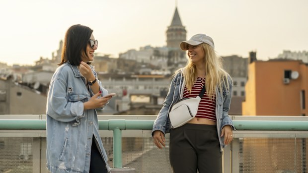two women talking next to the view of galata