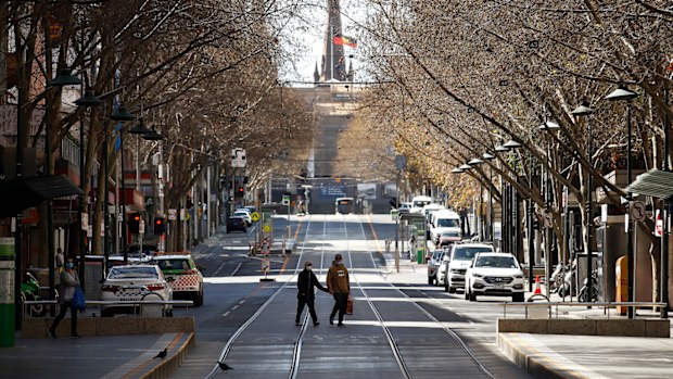 A woman is seen exercising along a quiet Bourke Street on September 06, 2020 in Melbourne, Australia. 