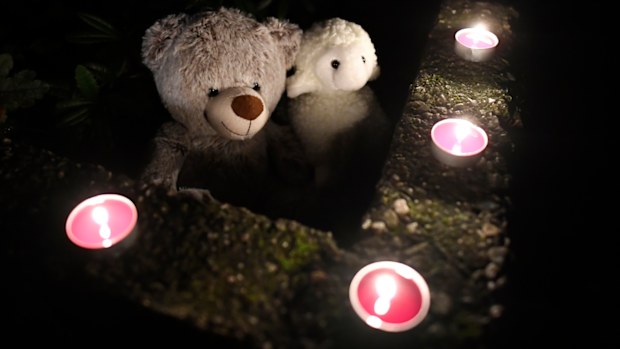 Teddy bears and candles are displayed in front of a house, Thursday, Sept. 3, 2020, in Solingen, Germany. 