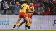 Lachlan Lam is congratulated after scoring for PNG.