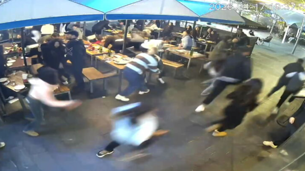 Patrons from surrounding restaurants were seen either fleeing in panic or hiding under tables after the attack began.