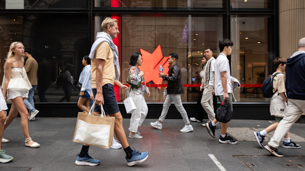 Pedestrians walk past an NAB office.