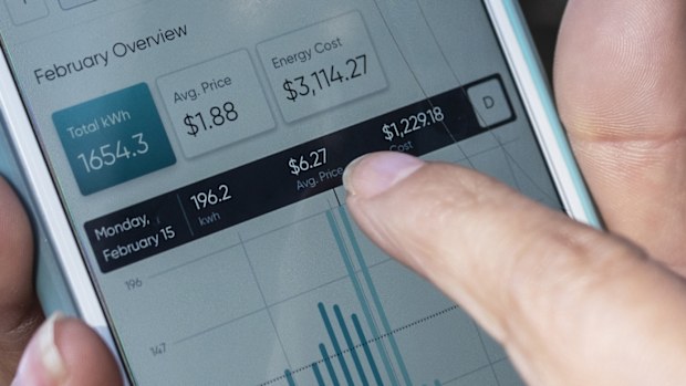 A consumer points to her electricity bill from Griddy energy on an app showing her energy cost of $3114.27.
