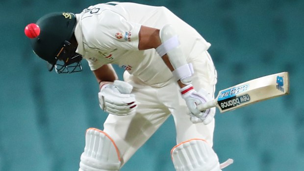 Harry Conway of Australia A is hit on the helmet.
