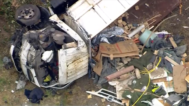 A truck driver is on the run after their vehicle colliding with a smaller truck on a Melbourne freeway, causing it to roll and leaving the other driver seriously injured.