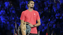 Alexander Zverev reflects on his 2025 Australian Open final loss to Jannik Sinner, with his runner-up plate tucked under his arm.