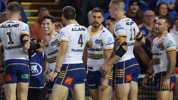 Mitchell Moses is congratulated by Eels players during their round 17 loss to the Knights.