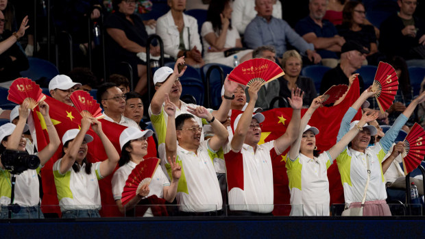 Chinese fans of Qinwen Zheng celebrate in Rod Laver Arena during her Australian Open semi-final win on Thursday.