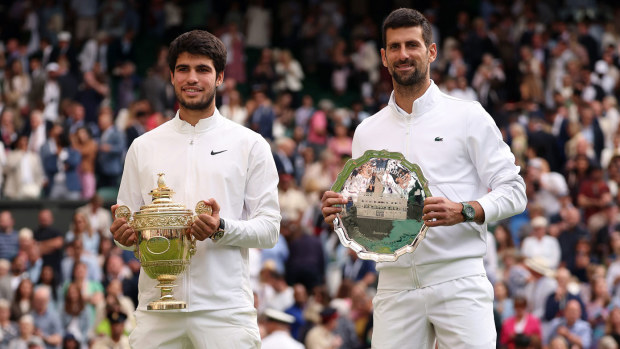 Carlos Alcaraz poses with the Wimbledon trophy after beating Novak Djokovic in the 2023 final.