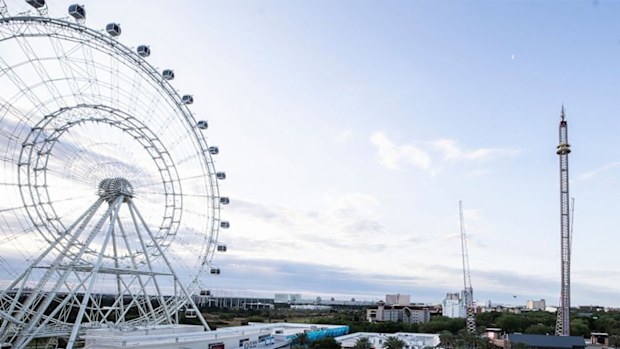 The Wheel and Orlando Free Fall ride at ICON Park is shown on Friday, March 25, 2022 in Orlando, Fla. A 14-year-old boy fell to his death from a ride at an amusement park in Orlando, sheriff's officials said. Sheriff's officials and emergency crews responded to a call late Thursday at Icon Park, which is located in the city's tourist district along International Drive. The boy fell from the Orlando Free Fall ride, which opened late last year. (Willie J. Allen Jr. /Orlando Sentinel via AP)
