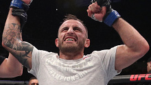 Alex Volkanovski has his hand raised after beating Jose Aldo.