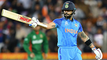 India's Virat Kohli celebrates a half-century against Bangladesh