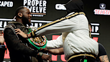Tyson Fury, of England, right, shoves Deontay Wilder during a face off for photographers at a news conference for their upcoming WBC heavyweight championship bout